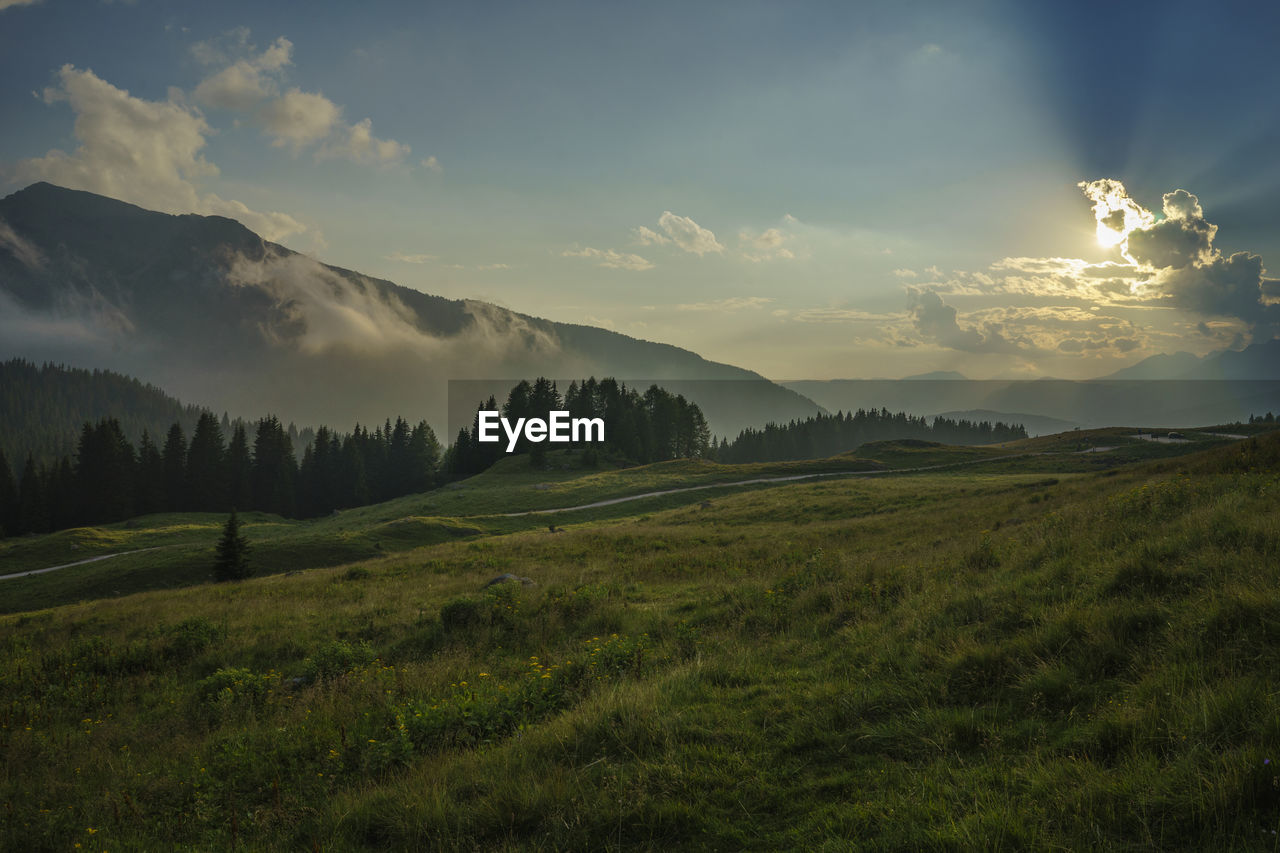 Scenic view of mountains against sky during sunrise