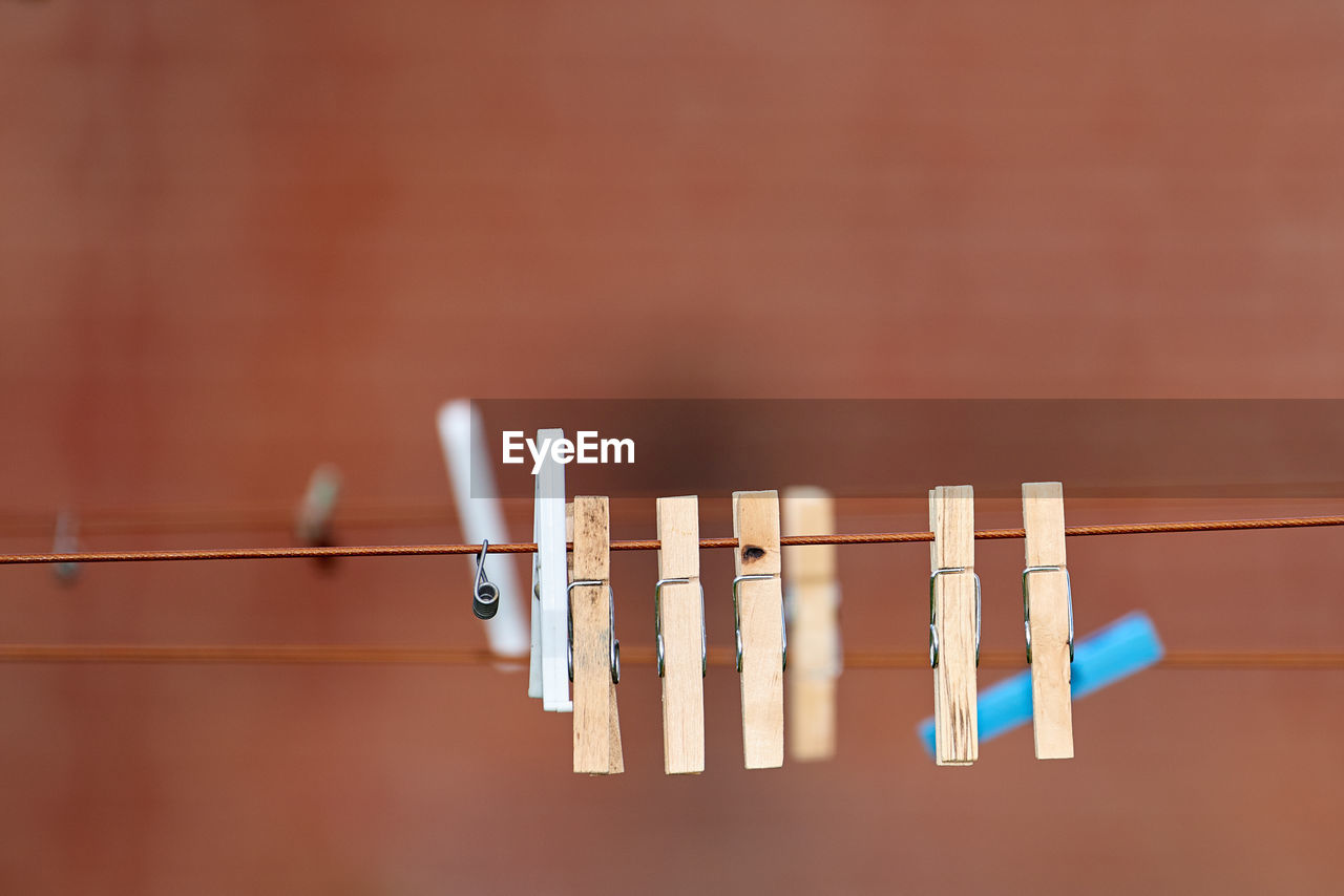 low angle view of clothespins hanging on rope