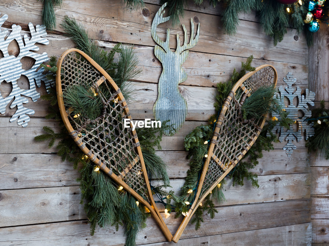 Christmas decorations including old vintage snow shoes and metal snowflakes and deer silhouette 