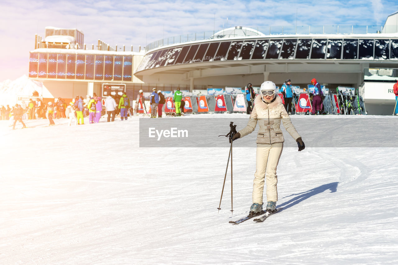 Full length of woman skiing on snow covered land