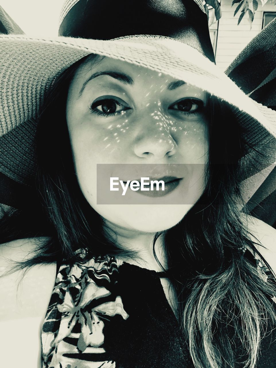 Close-up portrait of beautiful woman wearing hat