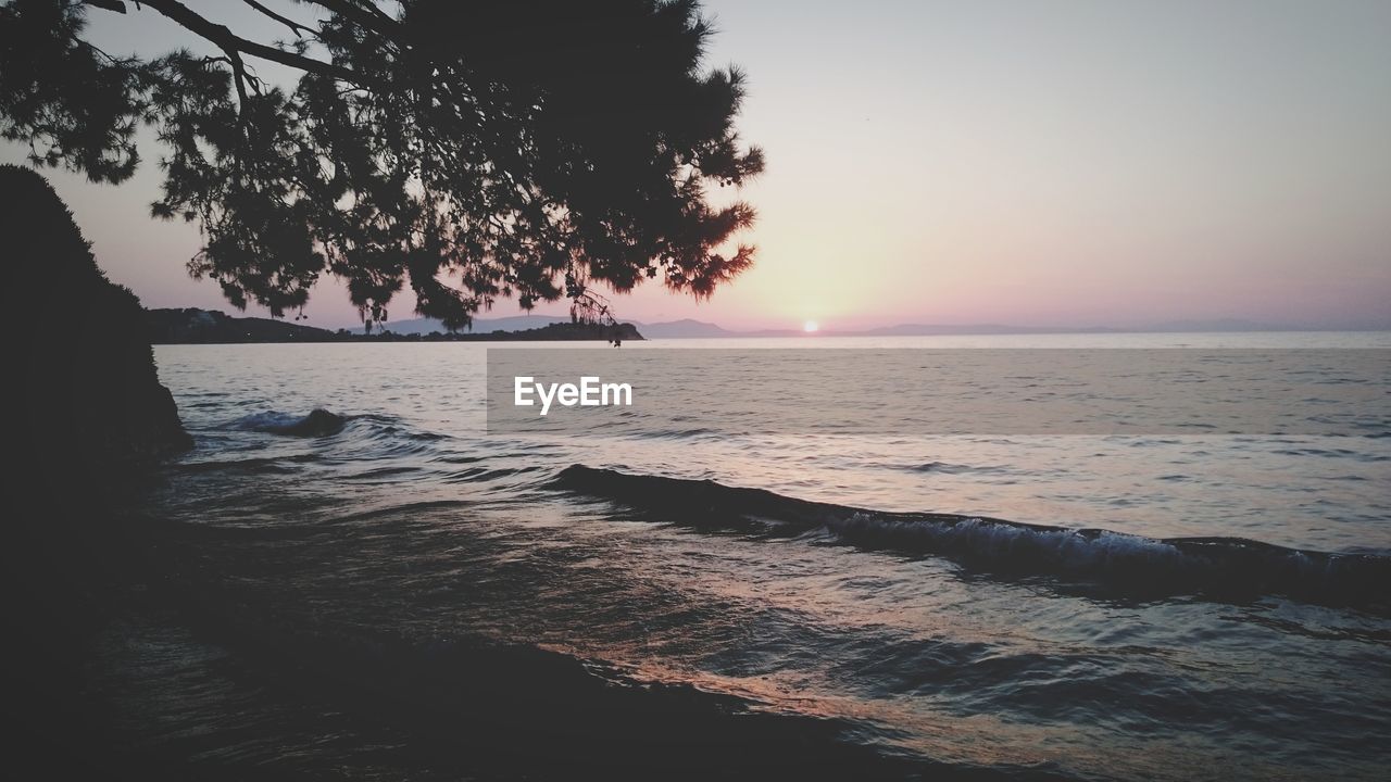 SCENIC VIEW OF BEACH DURING SUNSET