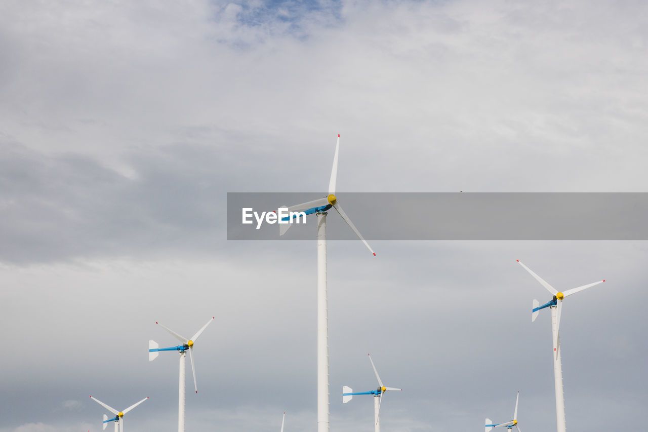 WINDMILLS AGAINST SKY