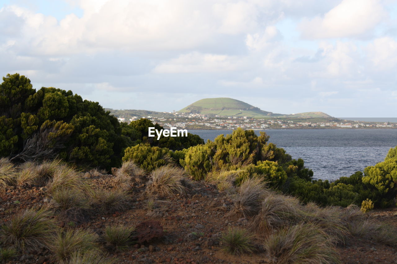 SCENIC VIEW OF MOUNTAINS AGAINST CLOUDY SKY