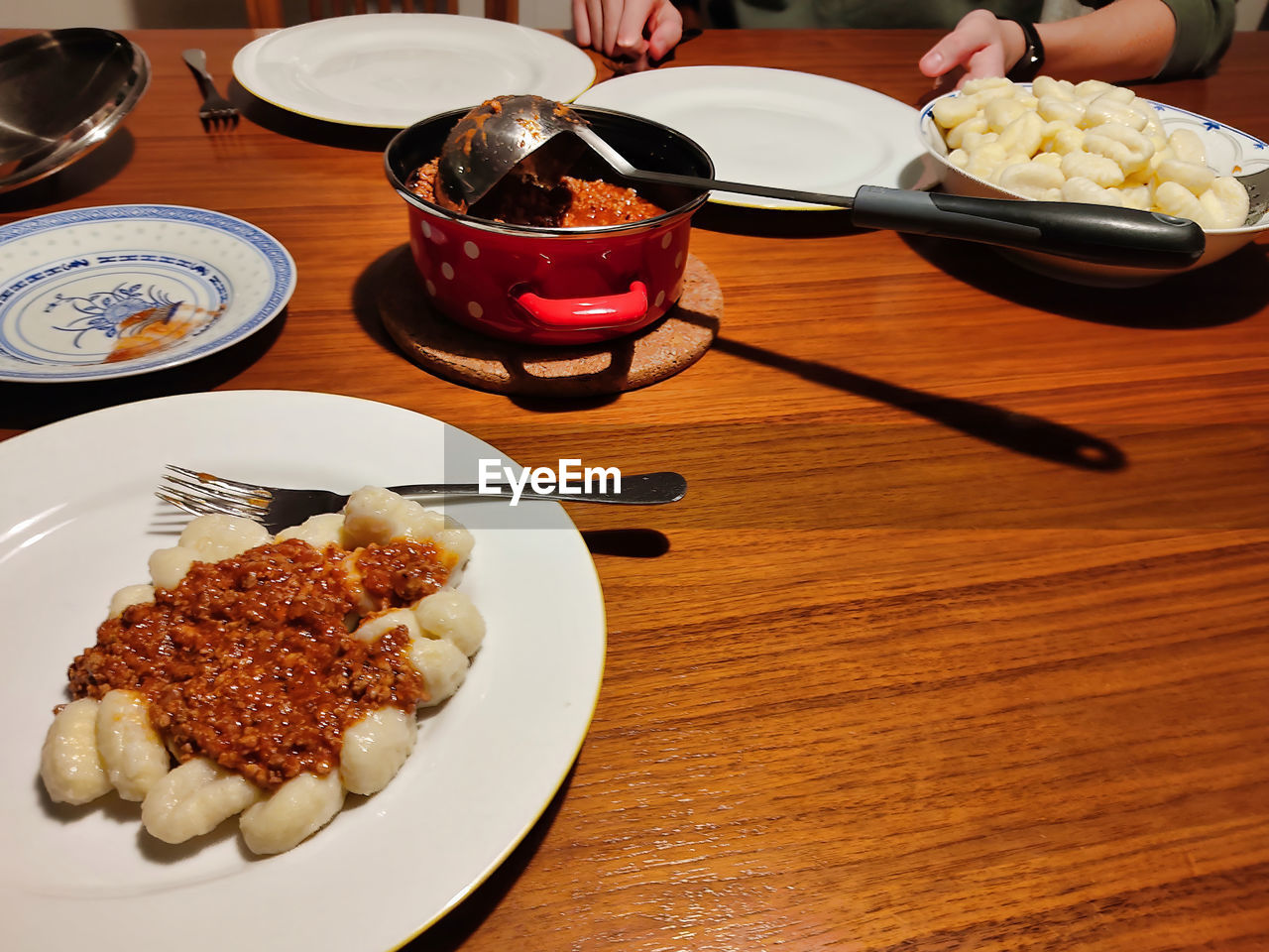 food and drink, food, table, plate, freshness, dish, meal, cuisine, indoors, dinner, healthy eating, serving size, hand, wellbeing, lunch, kitchen utensil, breakfast, high angle view, eating utensil, meat, wood, asian food, restaurant, bowl, tableware, crockery, household equipment, one person, supper, lifestyles, eating, chopsticks, fork, business