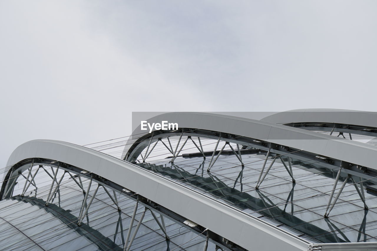 Low angle view of modern bridge against sky