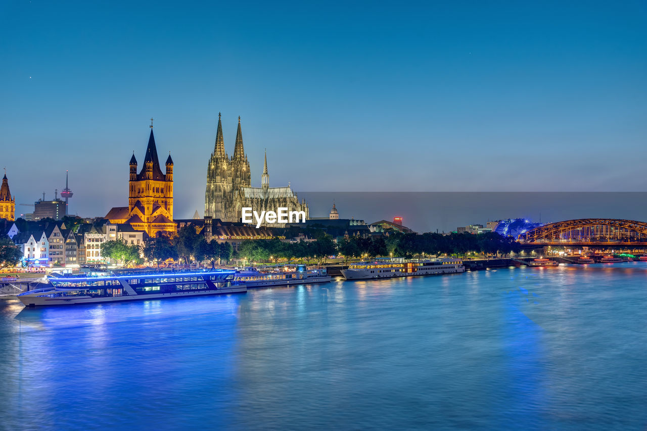The famous skyline of cologne with the river rhine at dusk