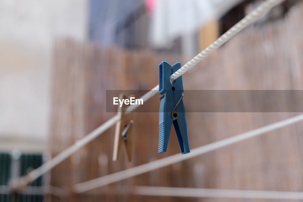 Low angle view of clothespins hanging on clothesline