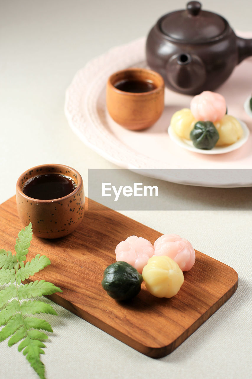 Three color kkultteok is ball shaped rice cake filled with honey and sesame syrup. 