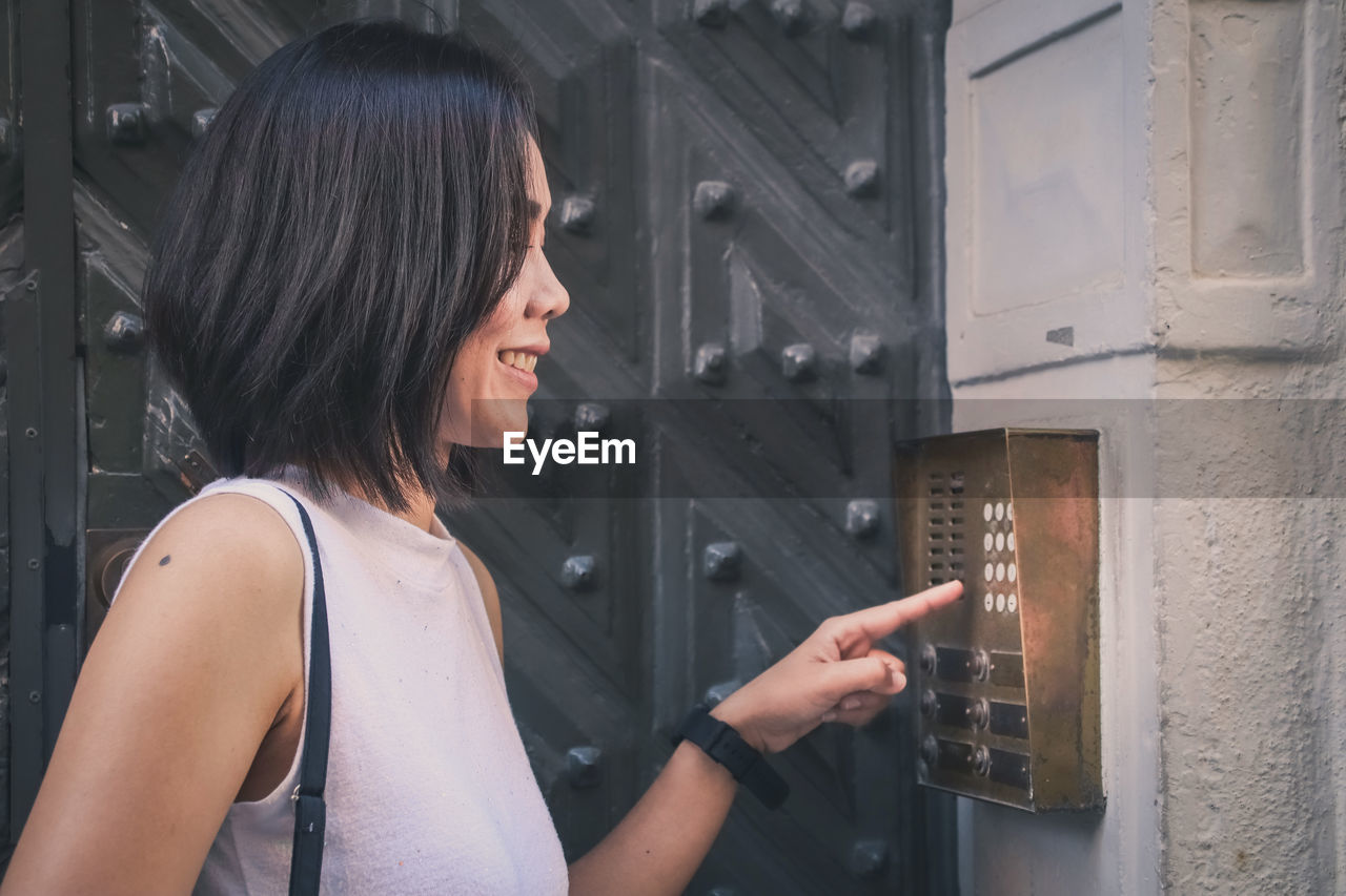 Close-up of smiling woman typing code