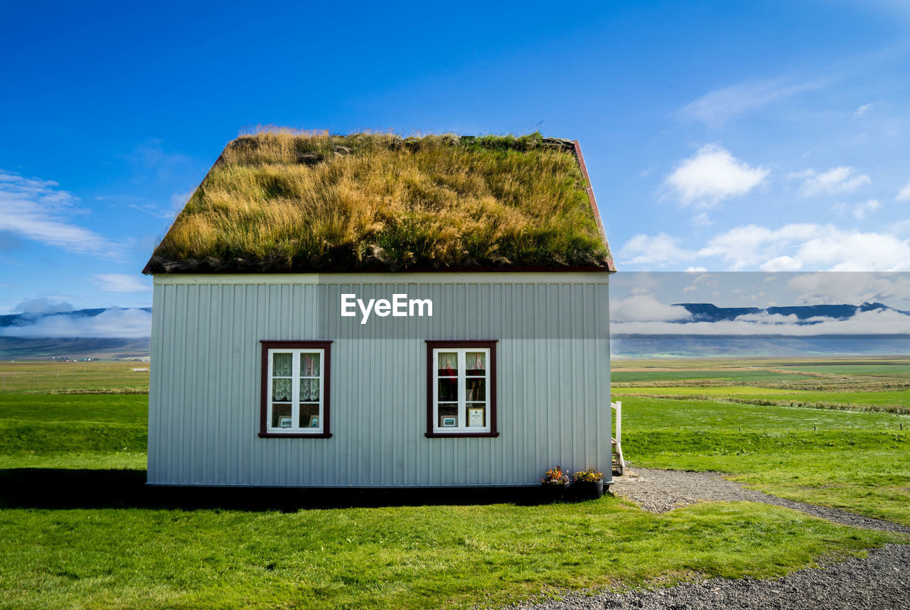 House on field against sky