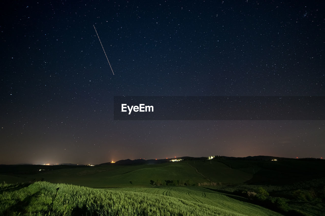 scenic view of landscape against star field