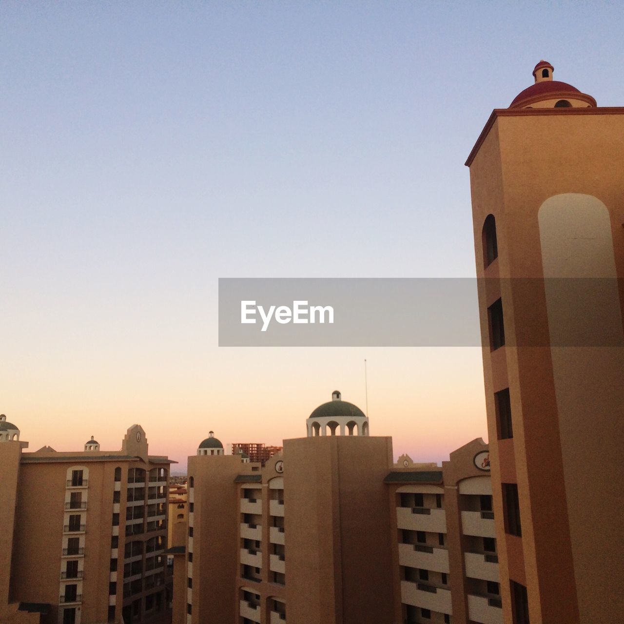 CITY BUILDINGS AGAINST CLEAR SKY