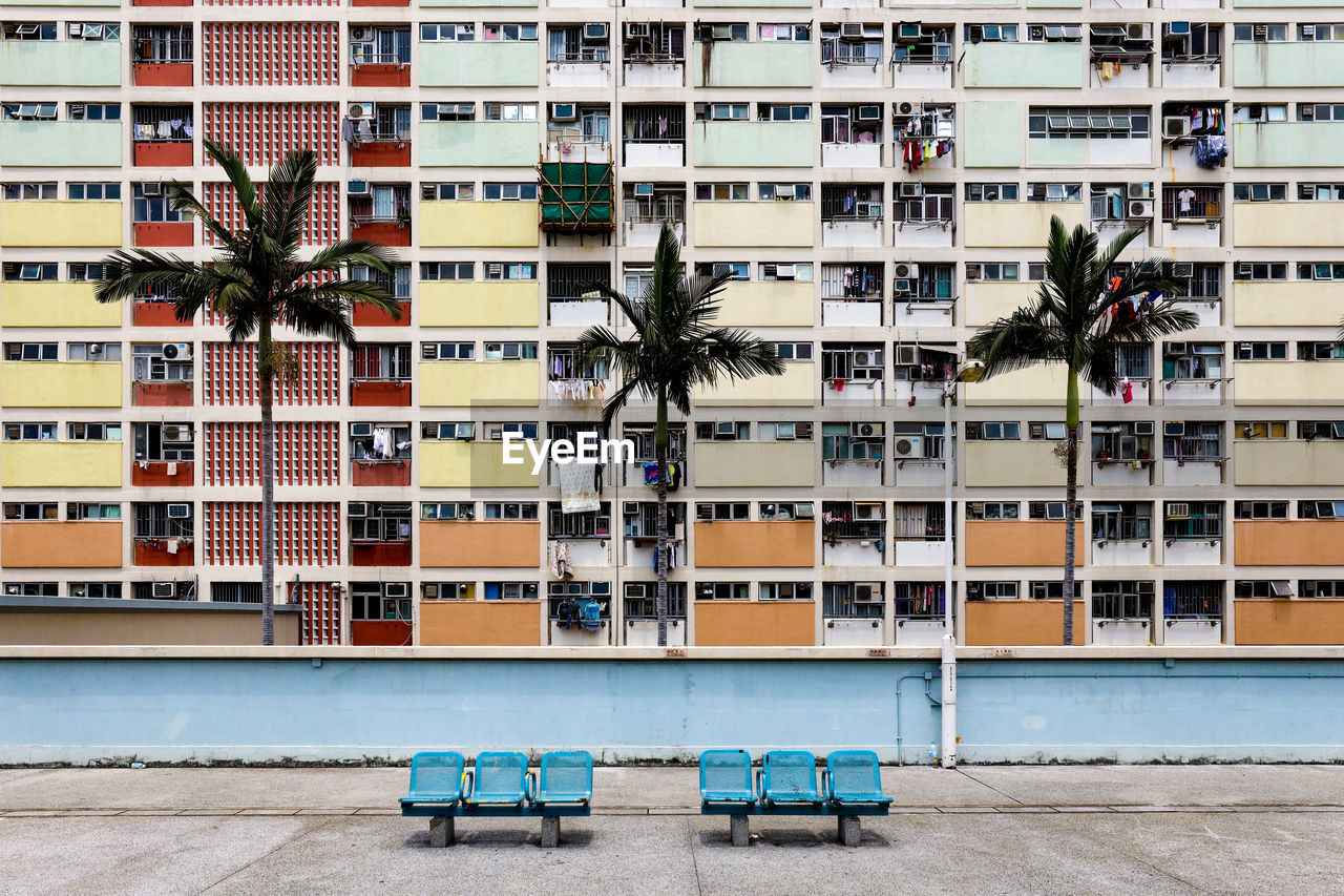 Empty benches against colorful building