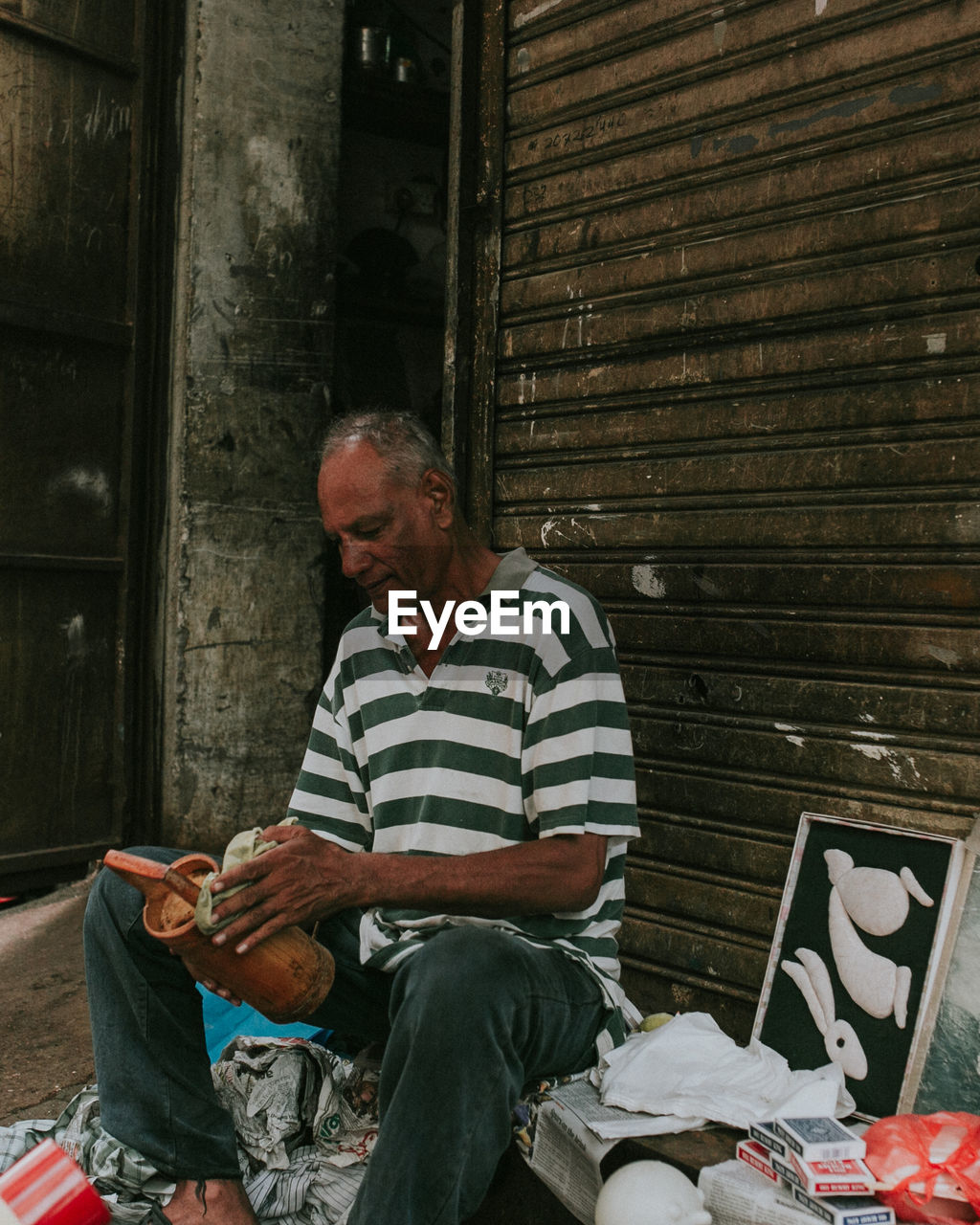 Vendor sitting by shutter