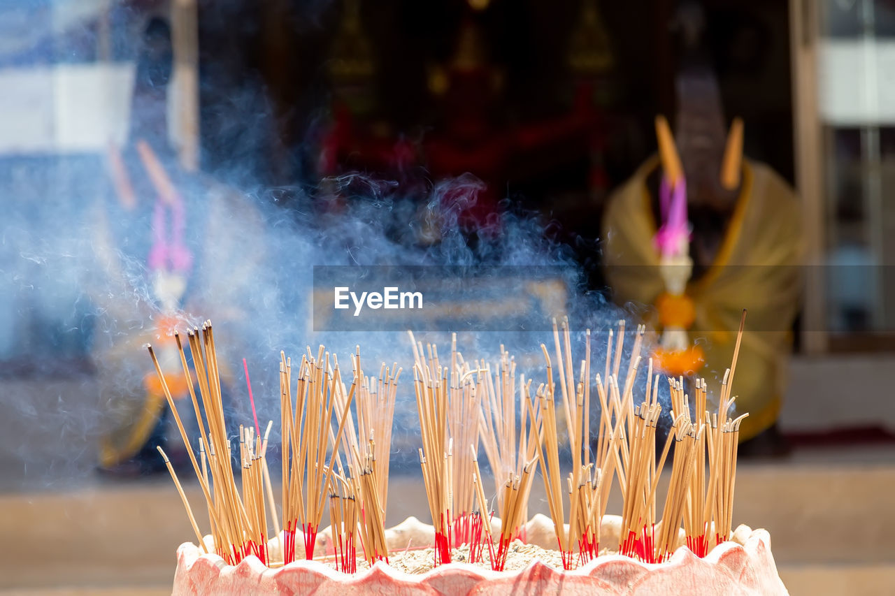 Incense sticks burning outside temple