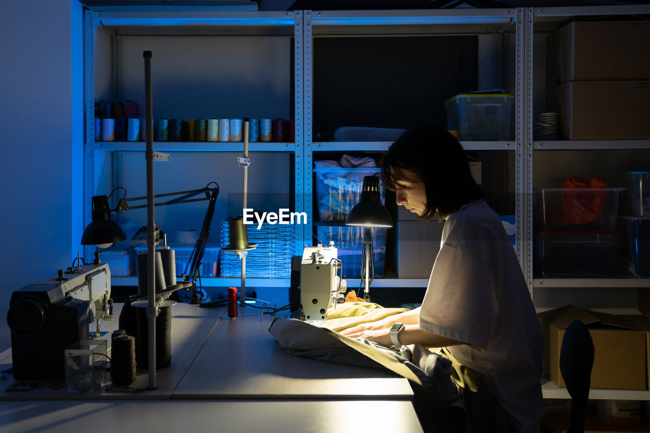 Side view of woman working on table