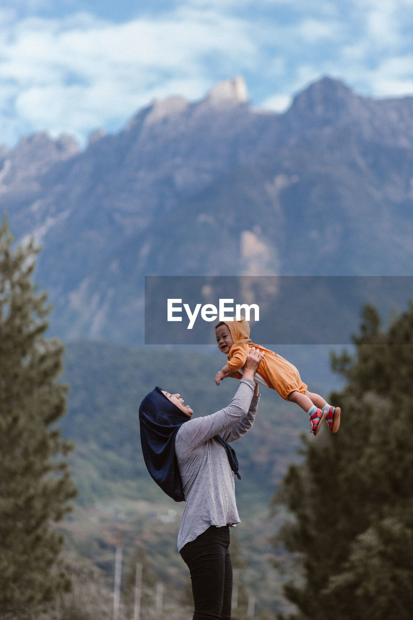 Full length of person standing on land against mountains