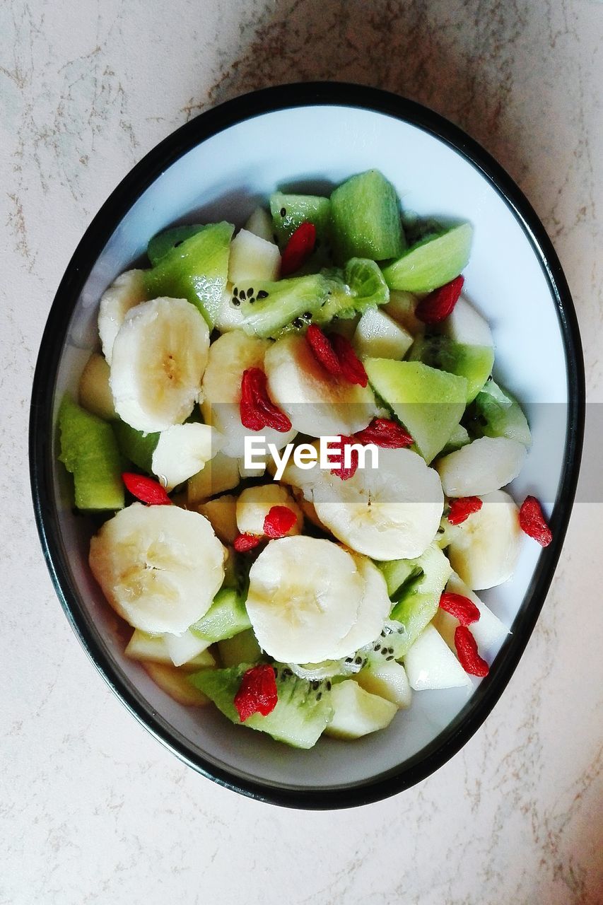 Directly above shot of fruit salad in bowl on table