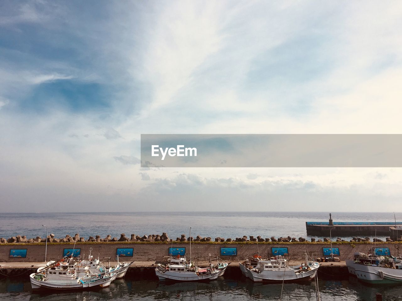 Boats moored in sea against sky