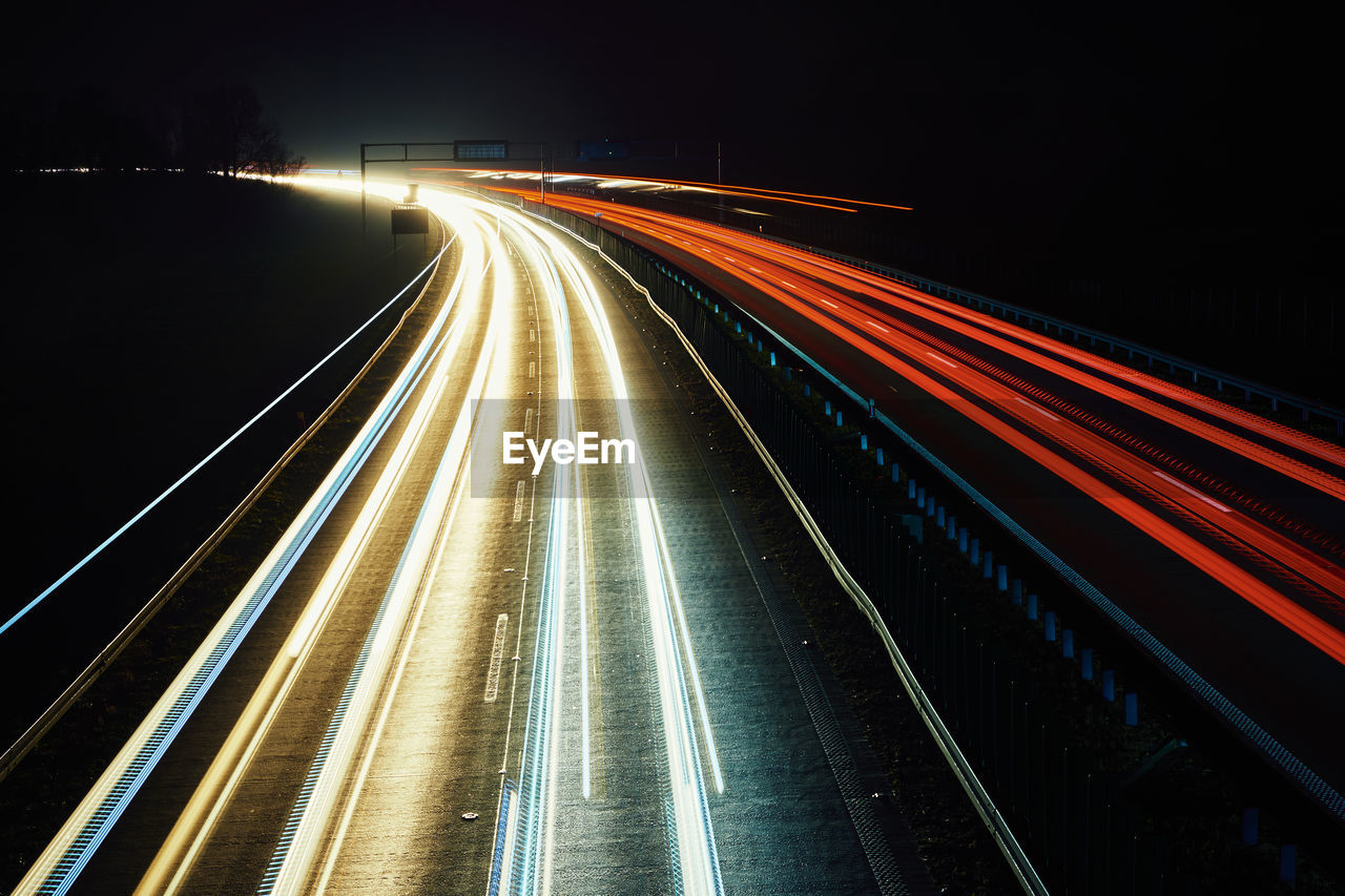 Moving car lights on highway at night, long exposure