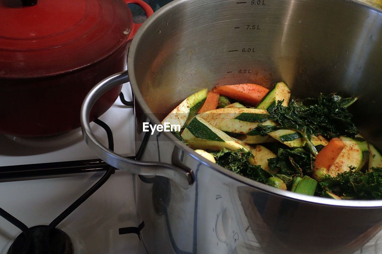 High angle view of fresh vegetables in utensil on stove