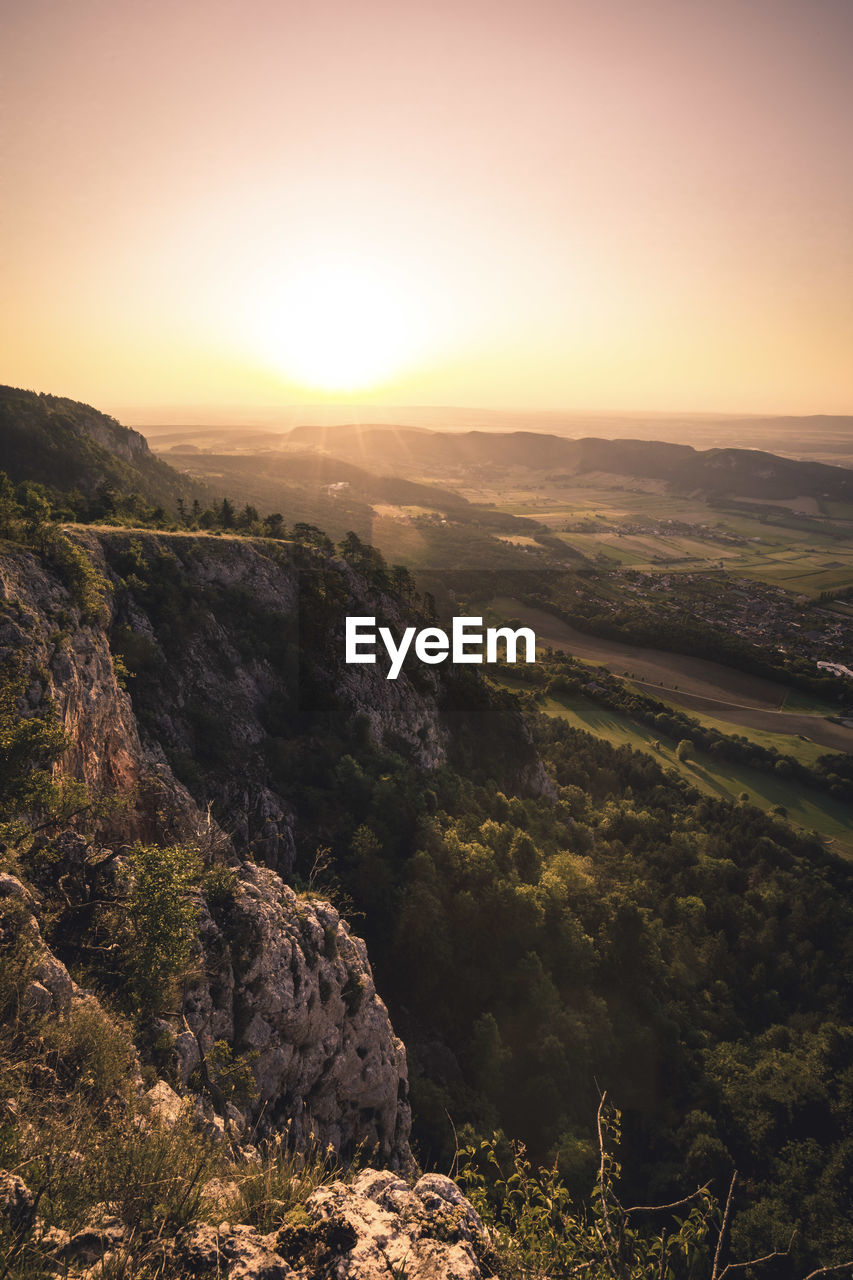 Scenic view of landscape against sky during sunset