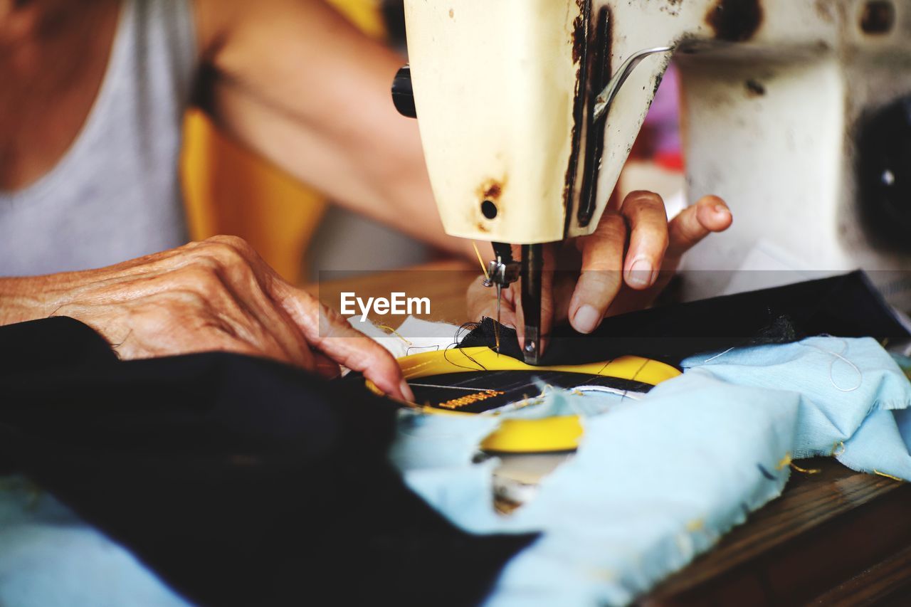 Midsection of man working in machine