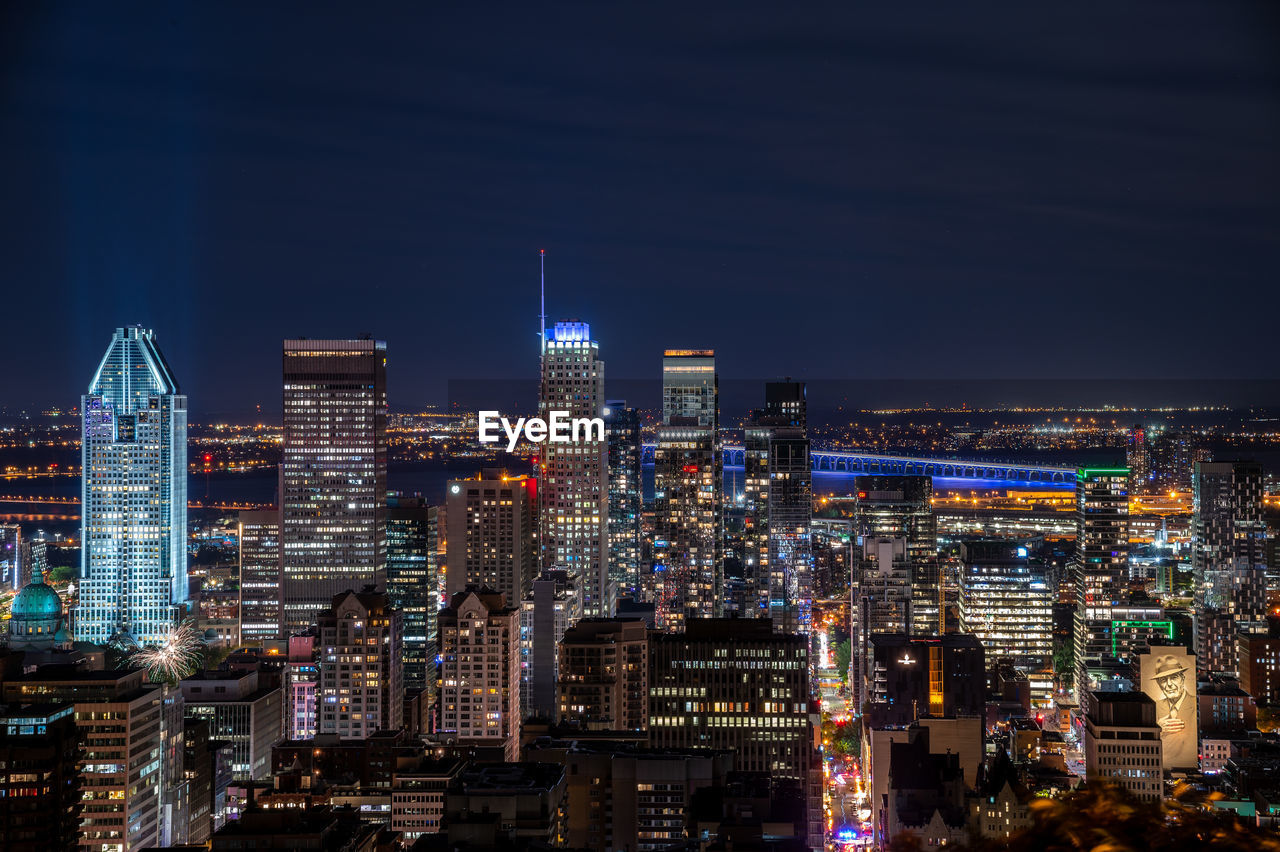 AERIAL VIEW OF ILLUMINATED BUILDINGS IN CITY