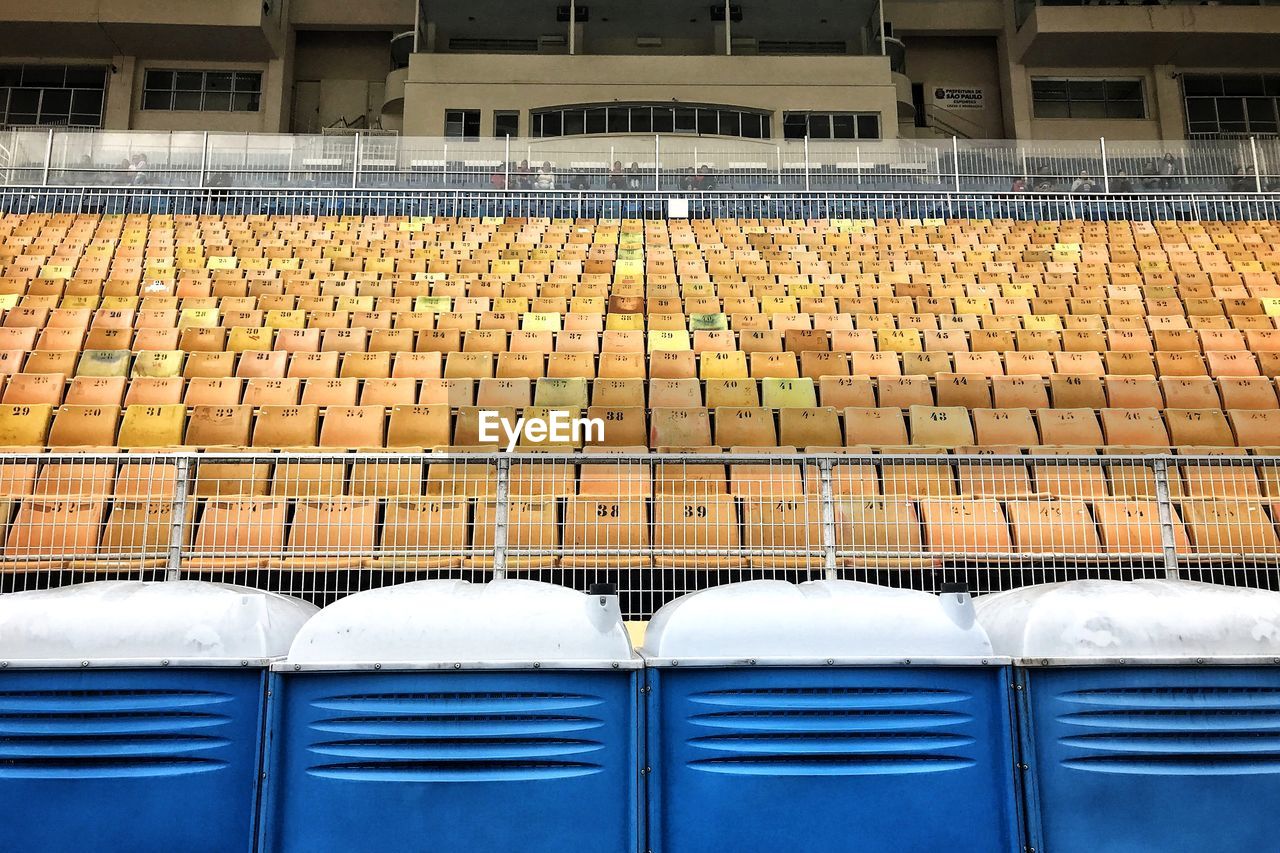 Close-up of empty seats in stadium building