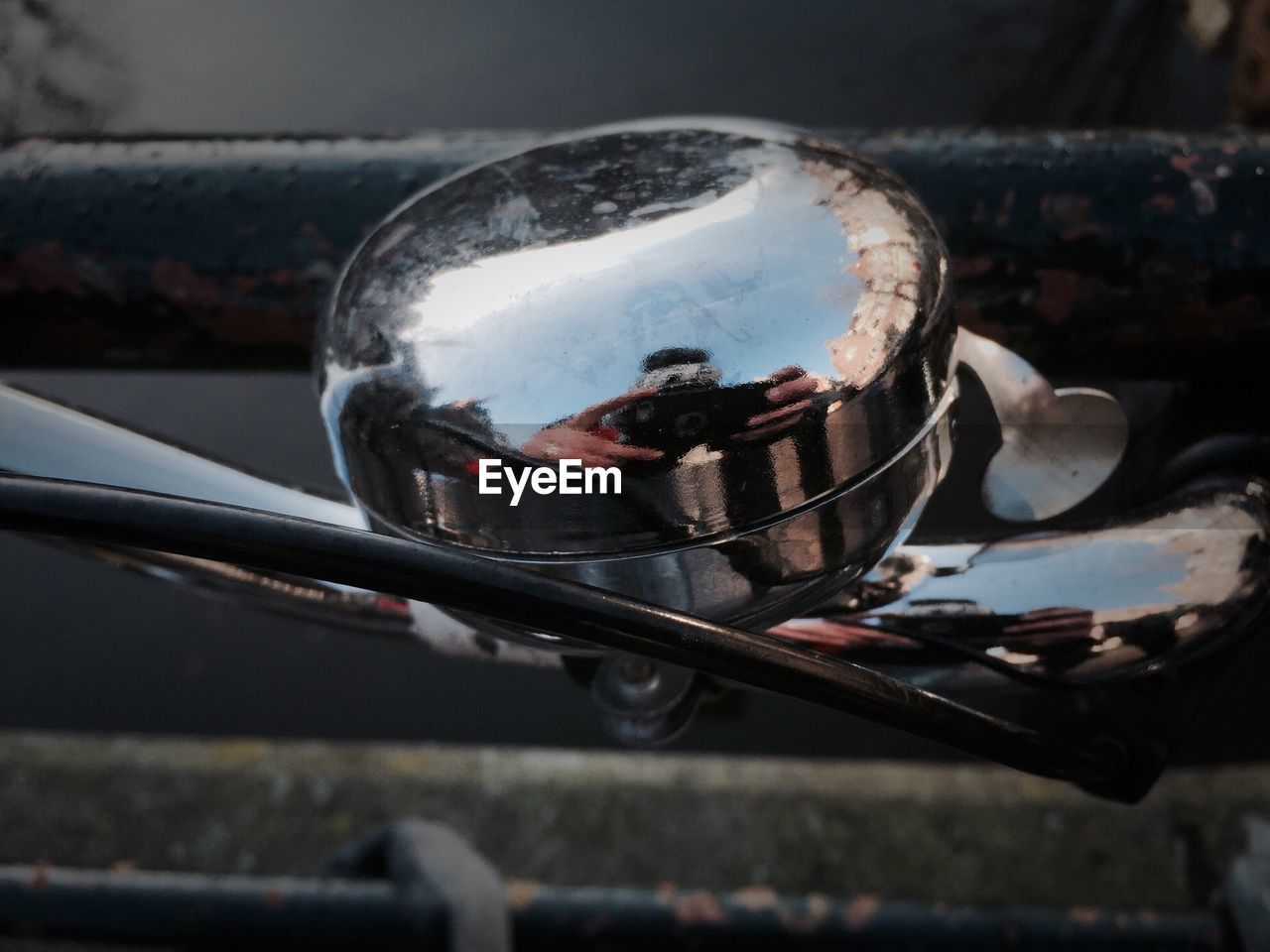 Man reflecting on bicycle bell