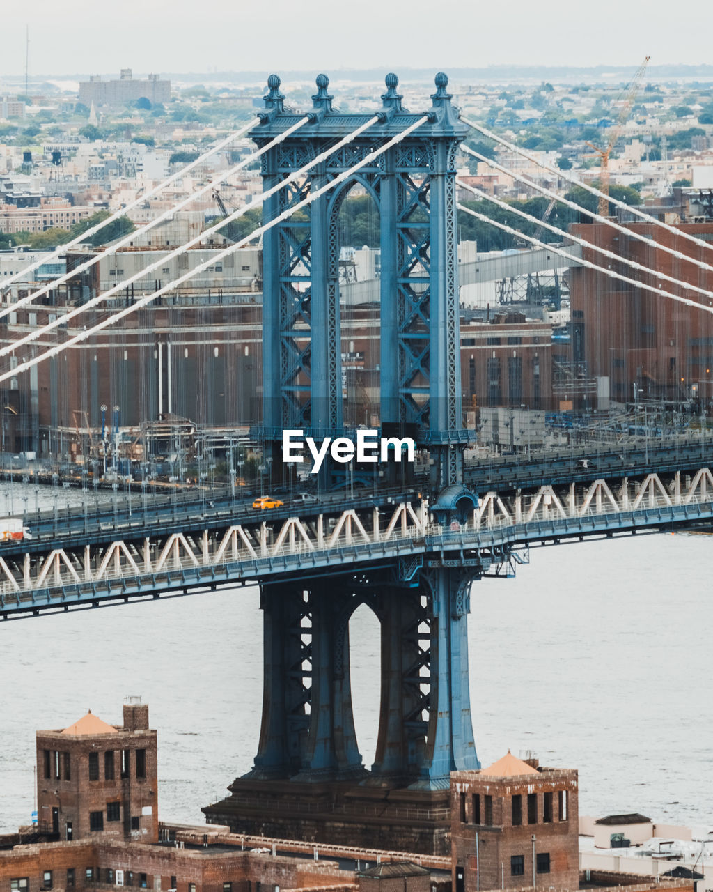 Manhattan bridge over river in city