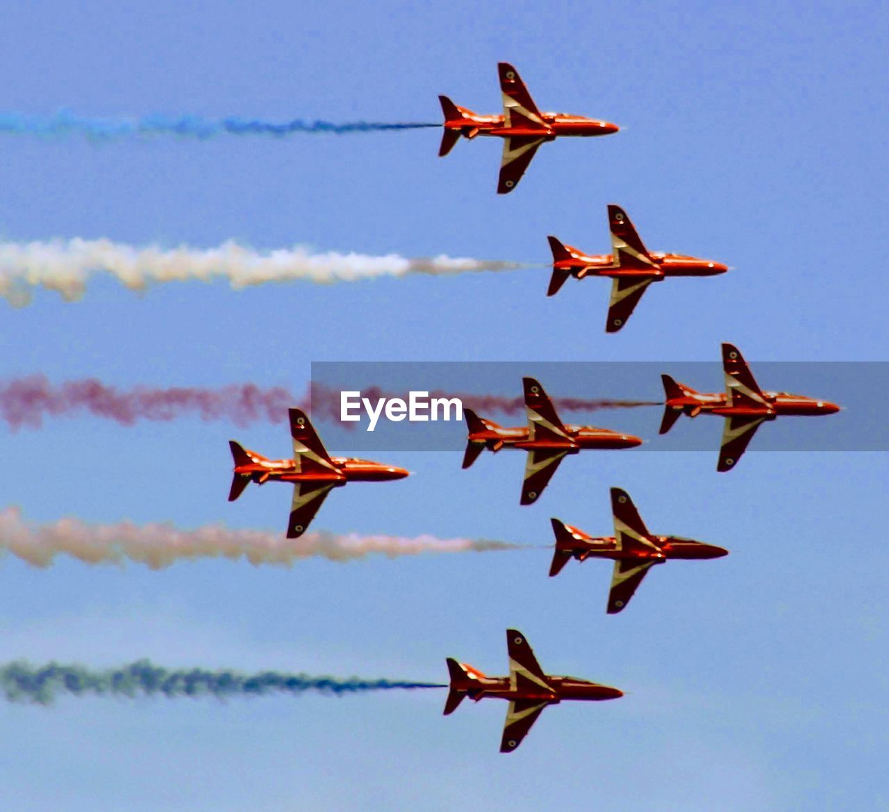 LOW ANGLE VIEW OF AIRSHOW IN FLIGHT AGAINST SKY