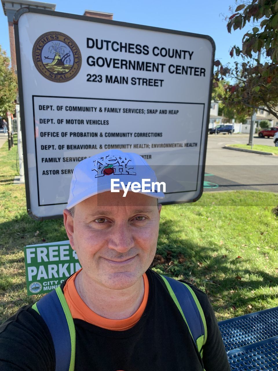 PORTRAIT OF MAN WITH TEXT ON SIGN