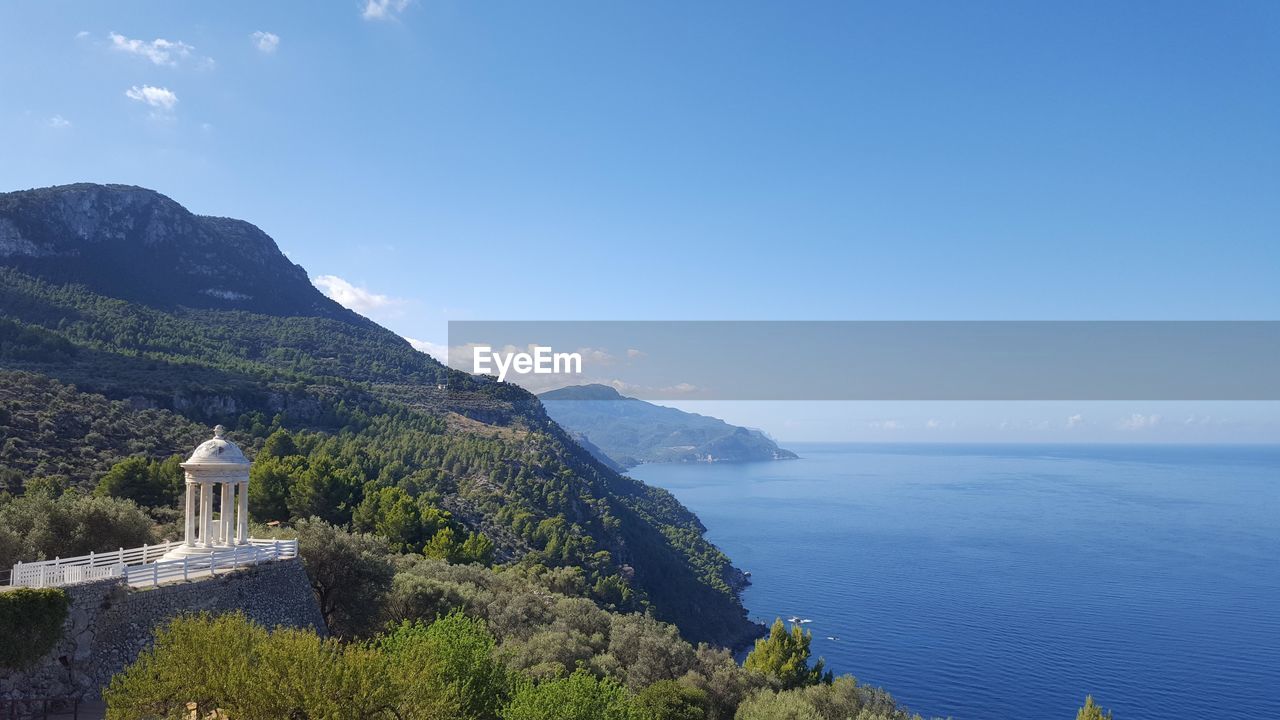 High angle view of sea and mountains against sky