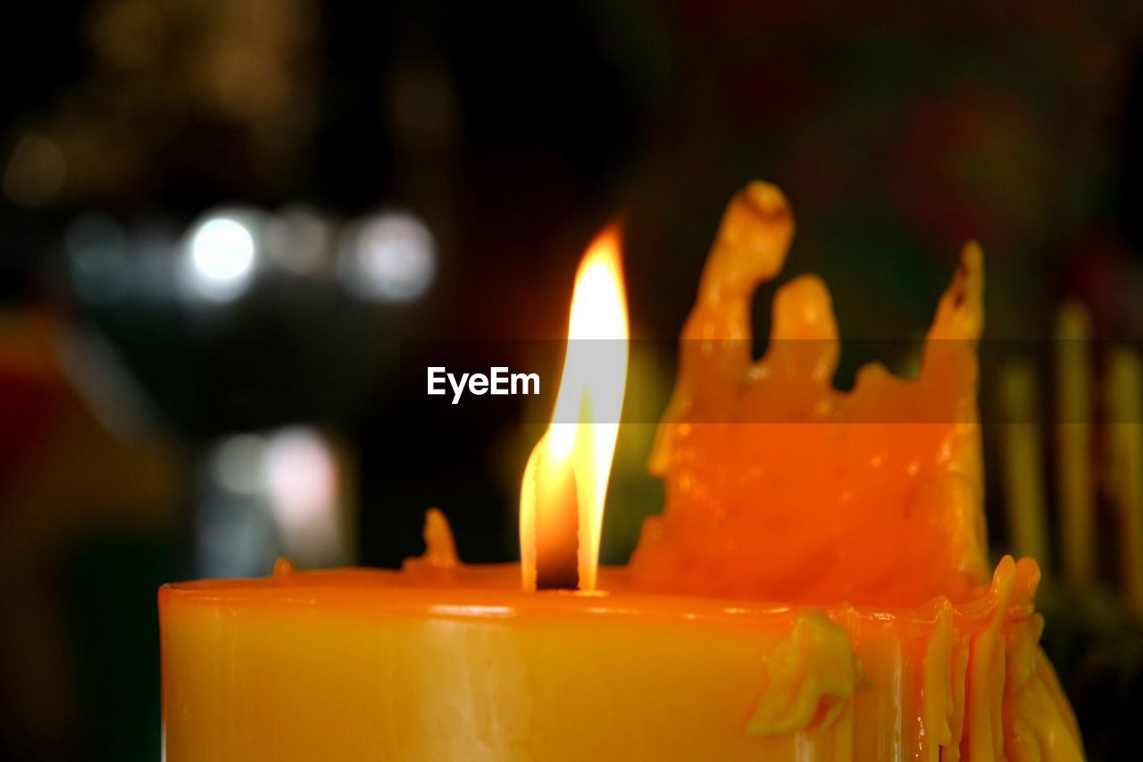 CLOSE-UP OF TEA CUP AND CANDLES