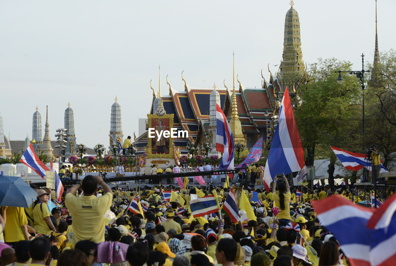 High angle view of people with thai flags at event outside temple