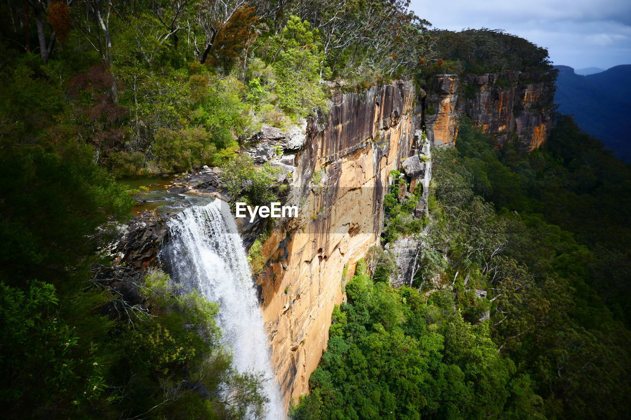 Scenic view of waterfall against sky