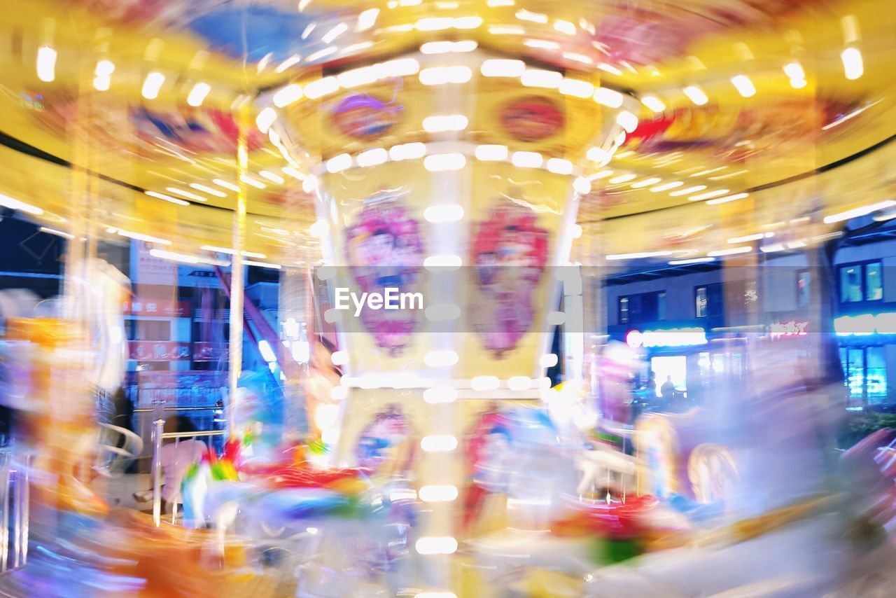 Low angle view of illuminated ferris carousel at night