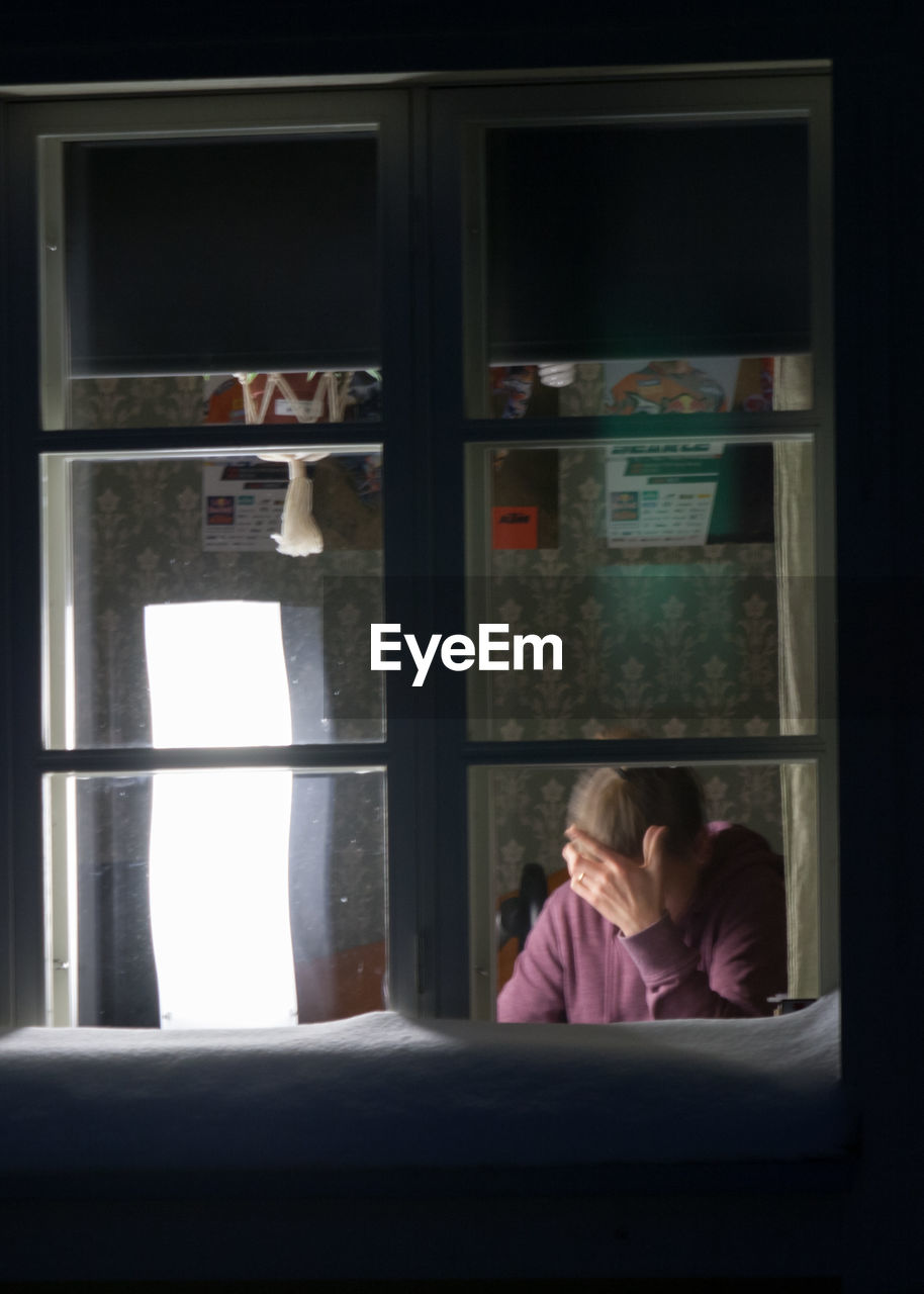 YOUNG COUPLE LOOKING AT WINDOW