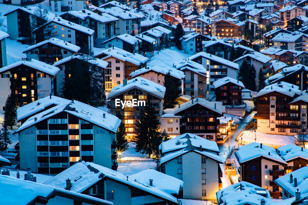 Snow covered houses in town during winter