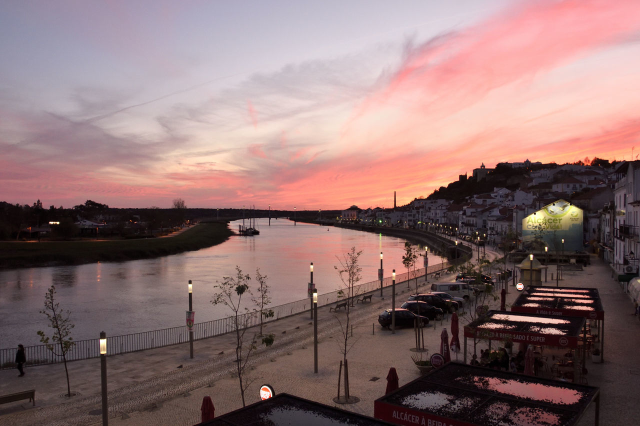 SCENIC VIEW OF RIVER BY CITY AGAINST SKY