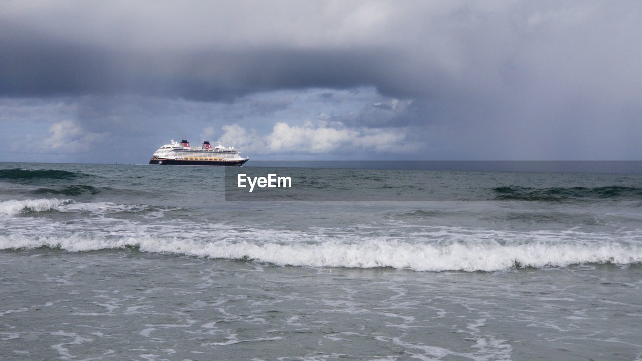 Boat sailing in sea against sky