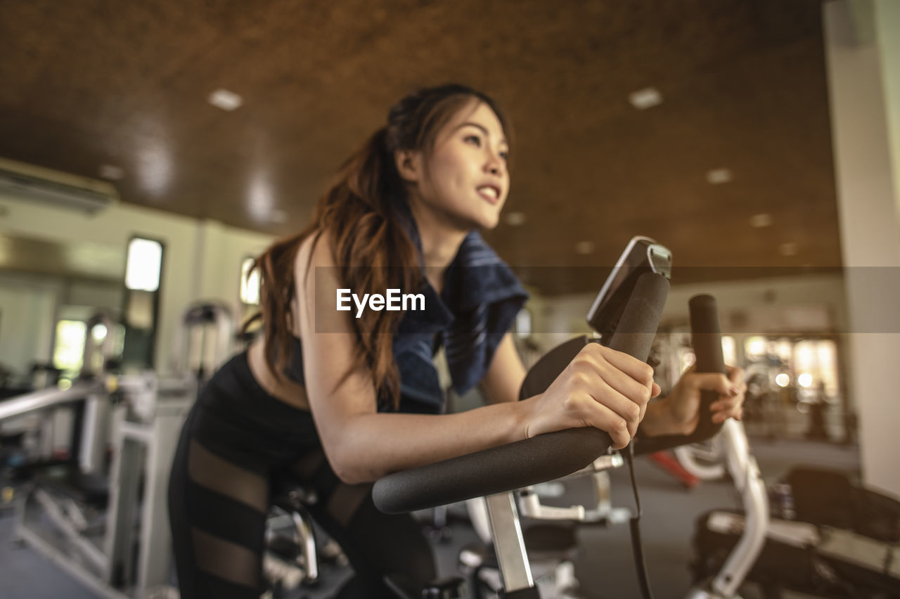 Low angle view of woman exercising in gym