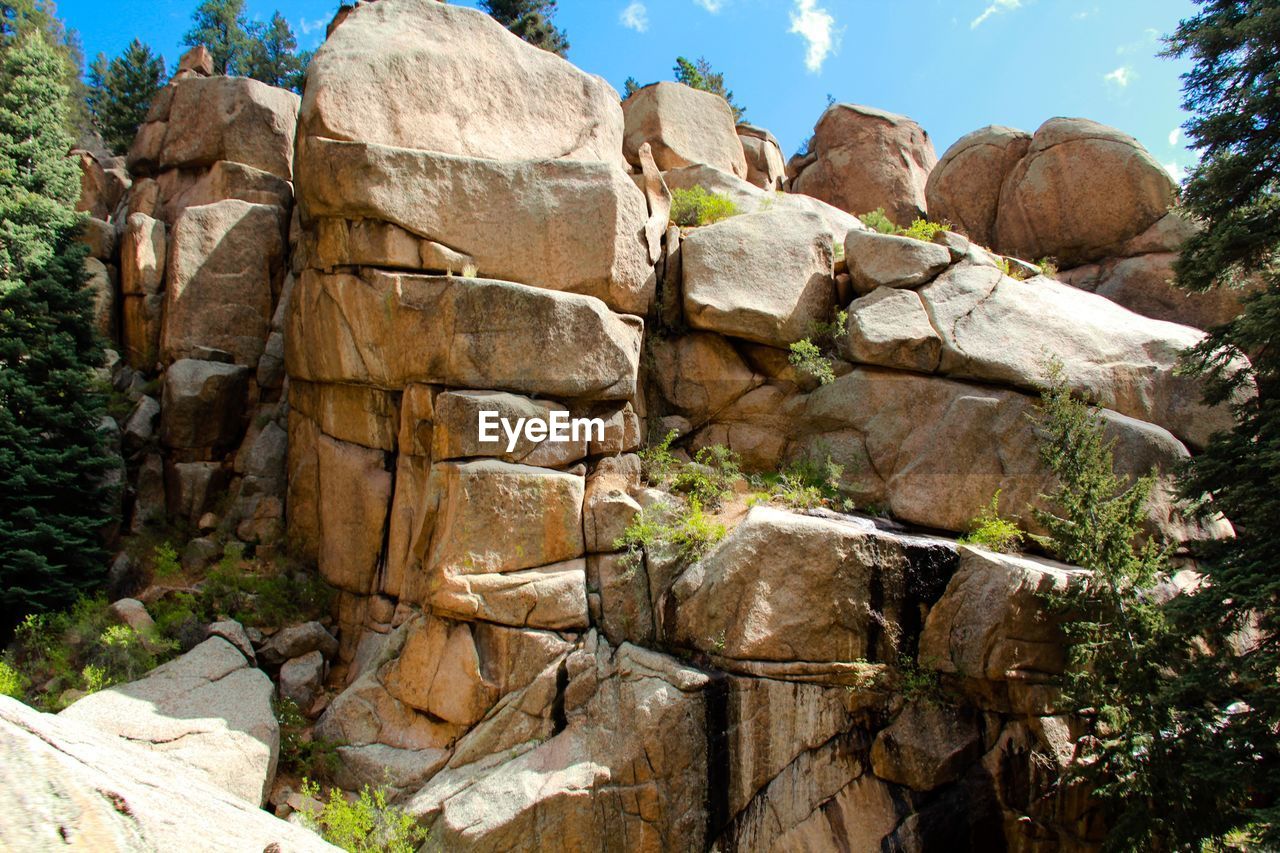 Low angle view of rocks against sky