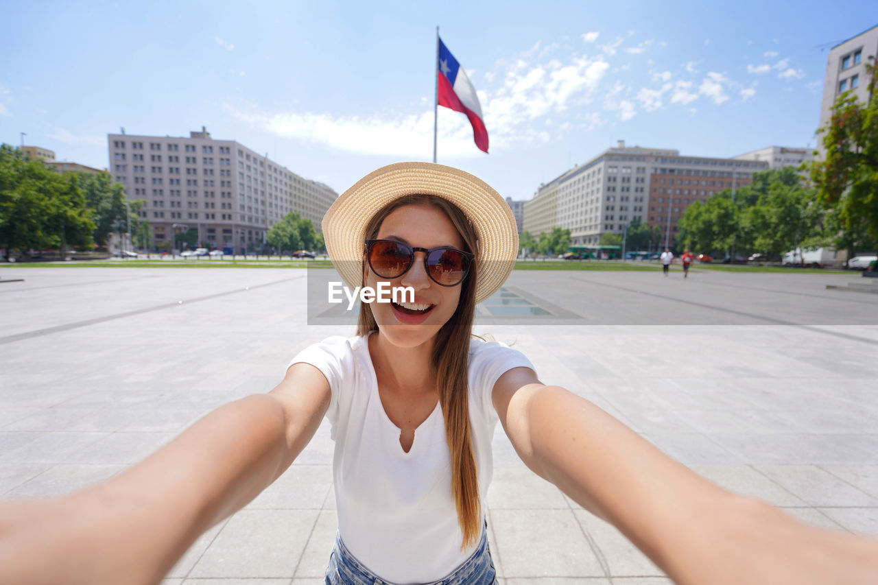 Self portrait of traveler girl visiting the city center of santiago, chile, south america