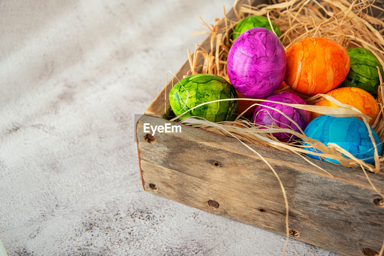 multi colored, easter, easter egg, no people, food, still life, high angle view, tradition, food and drink, basket, egg, celebration, container, holiday, nature, close-up, freshness, wood, decoration, indoors