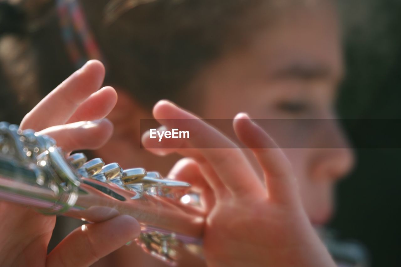 Close-up of boy playing flute