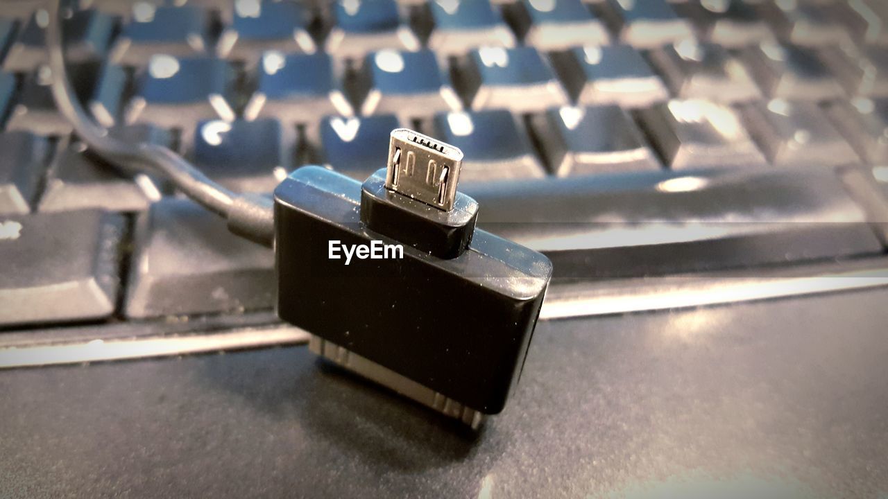 Close-up of network connection plug by keyboard on table