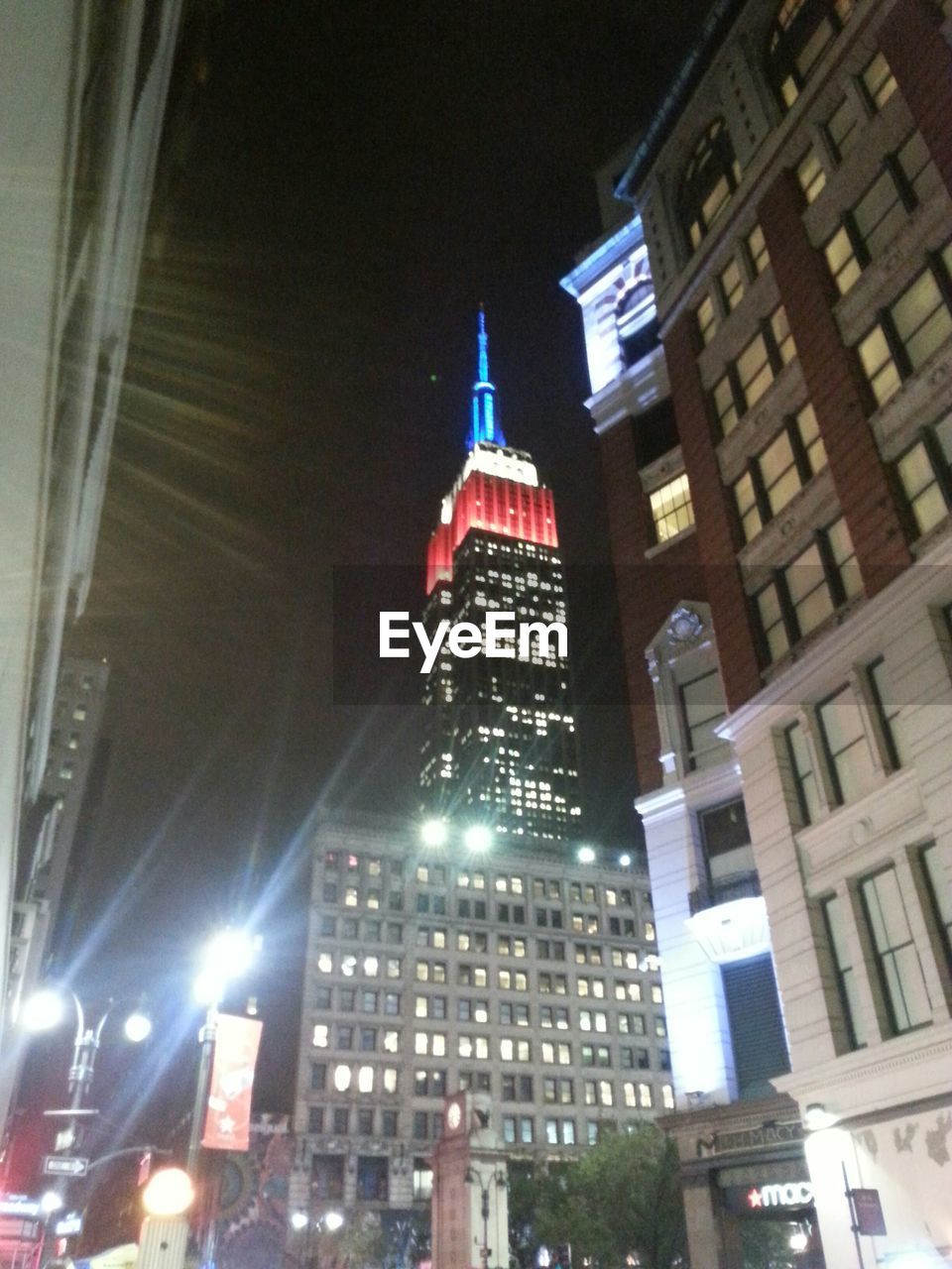 LOW ANGLE VIEW OF MODERN BUILDINGS AT NIGHT